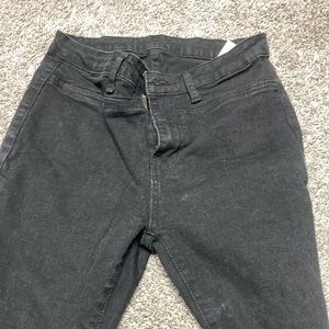 Black flared jeans with pink,purple and blue flowers on one pant leg